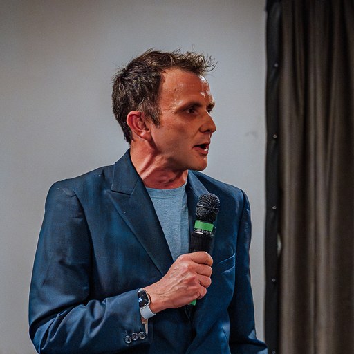 Rory Mason, Founder and CEO of 21 Degrees Digital, presenting with a microphone.